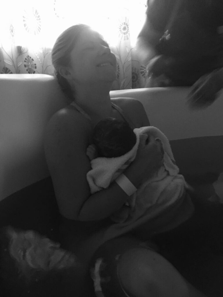 mum holding newborn baby- water birth at white horse birth centre
